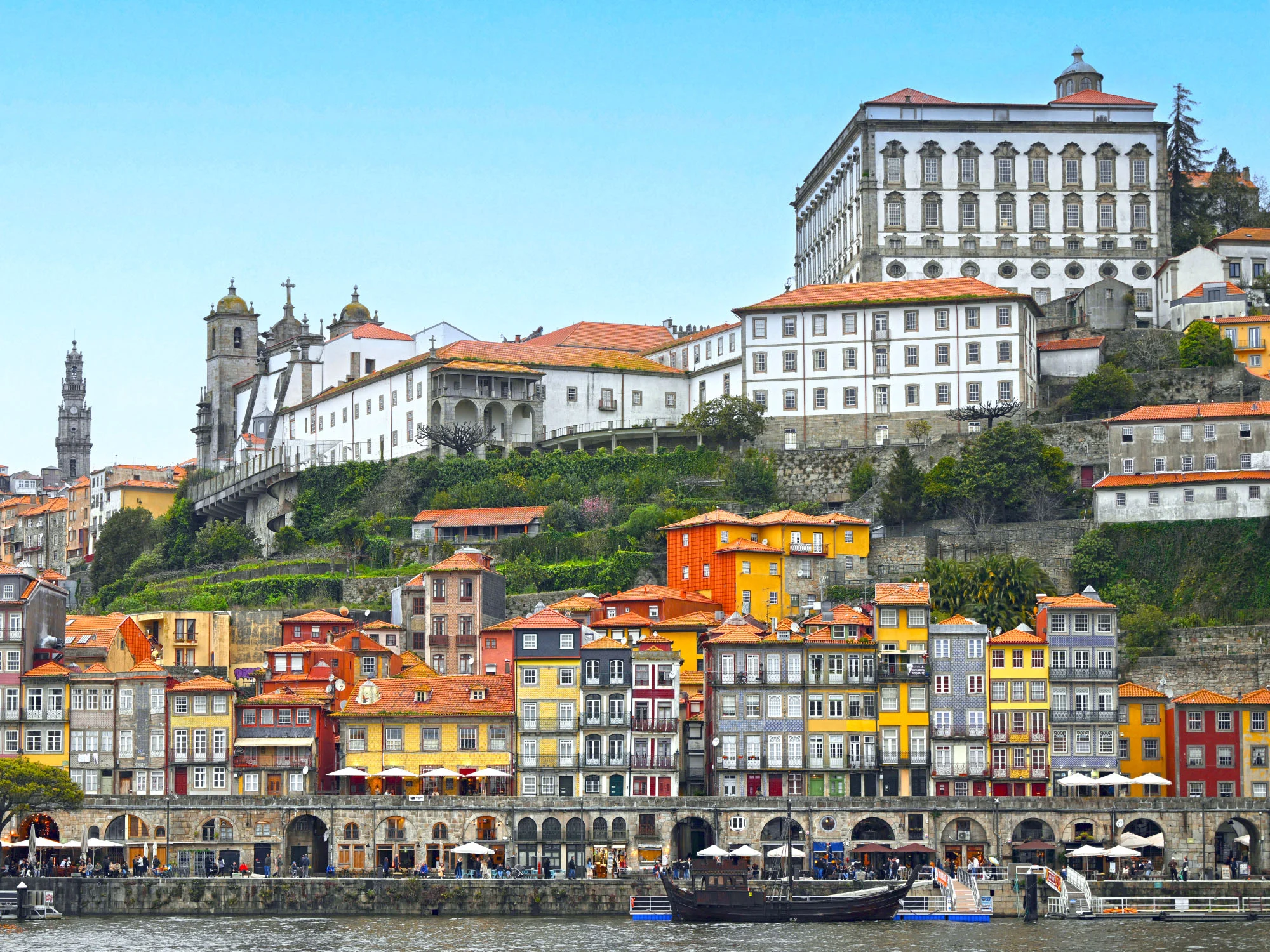 Porto's colorful Ribeira waterfront rises in terraces beneath the city's medieval skyline, where merchants, pilgrims, and explorers shaped the history of Portugal