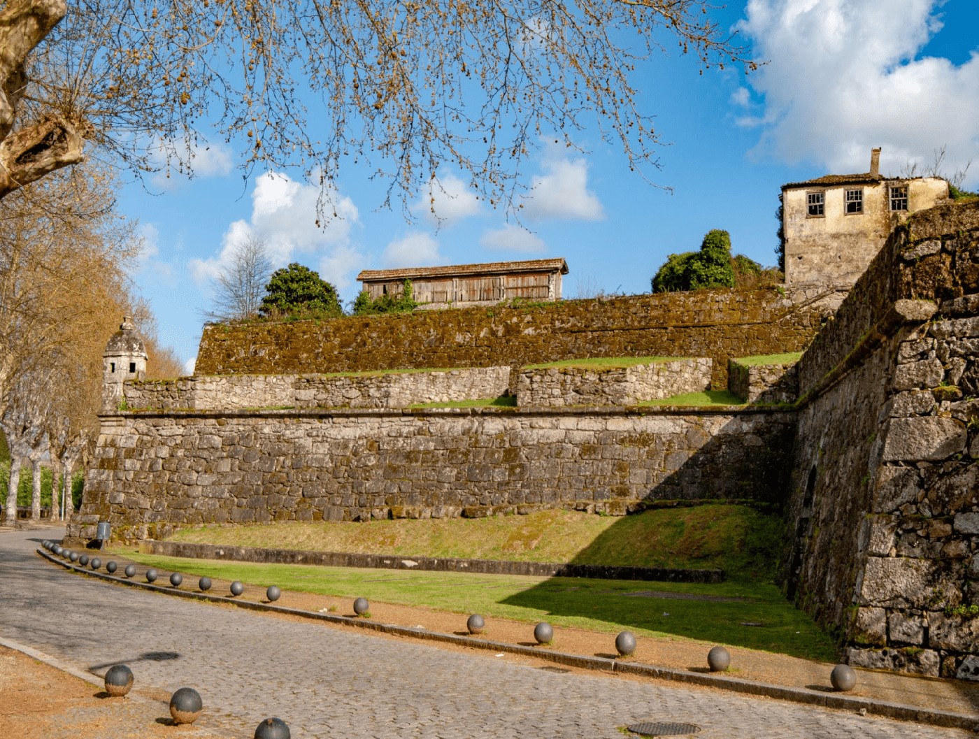Historic stone walls and fortifications of the Fortaleza de Monção in Monção, Portugal, beneath a blue sky